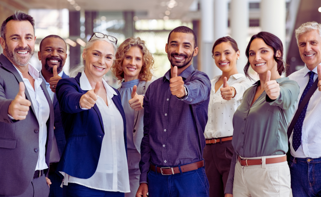 candidates for executive leadership program giving a thumbs up ands smiling